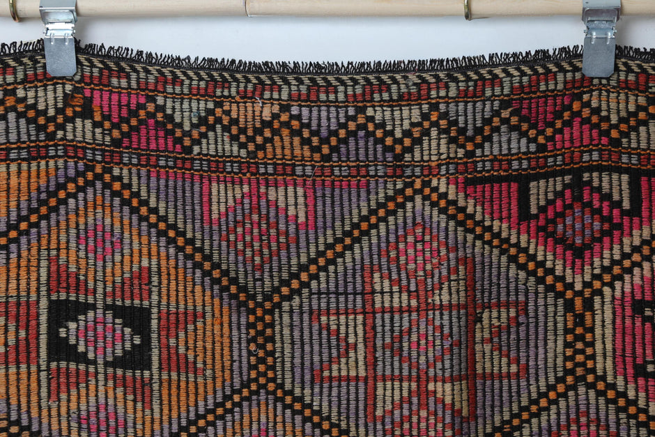 Close-up of handmade wool cotton kilim rug showing dense oriental lattice pattern in warm tones