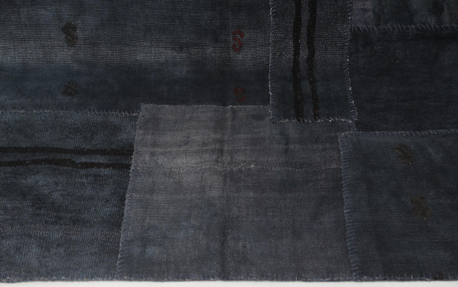Back side of handmade dark blue hemp patchwork rug showing weave texture