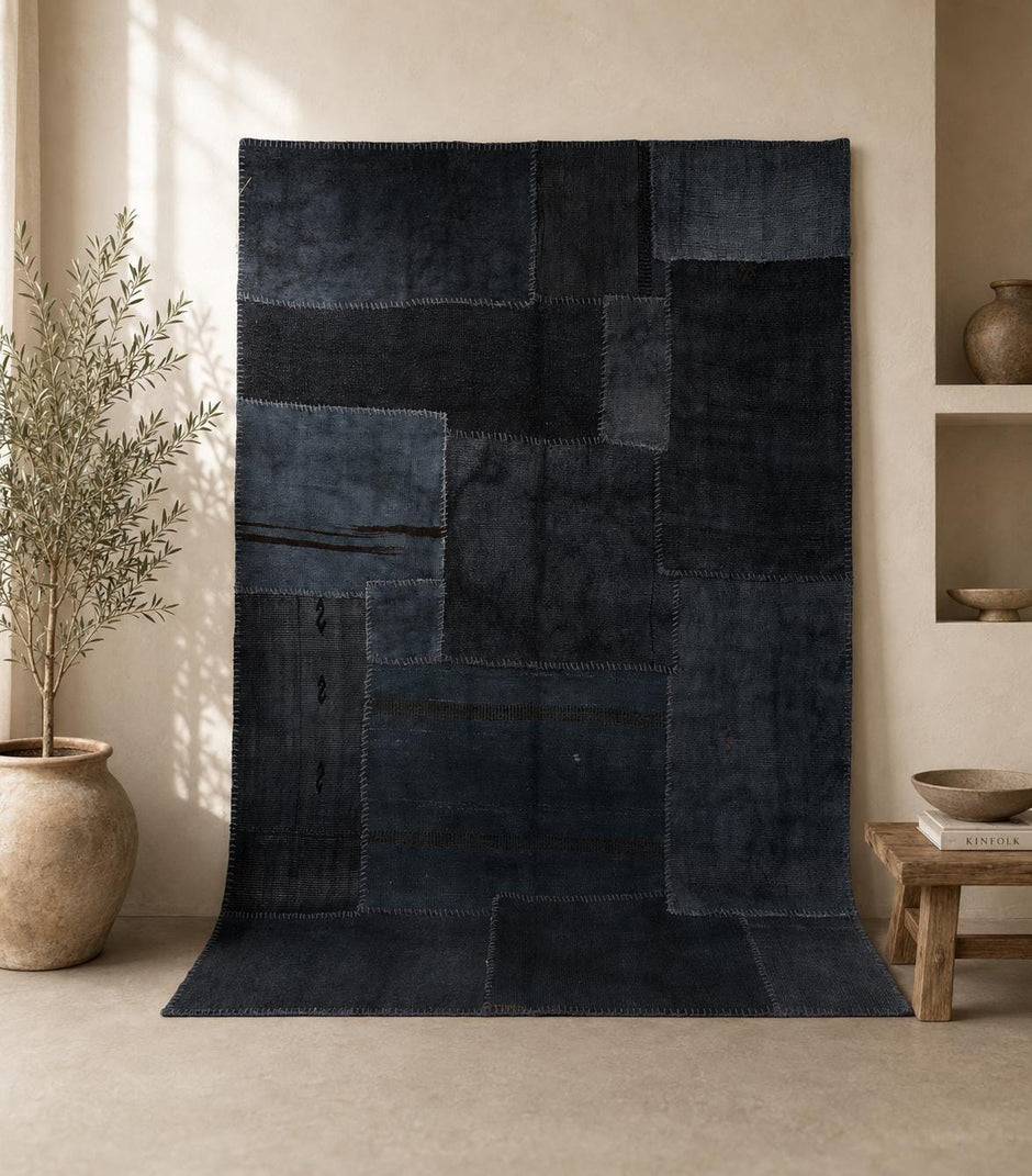  5x7 vintage hemp patchwork rug hanging in styled room showing deep indigo blue panels