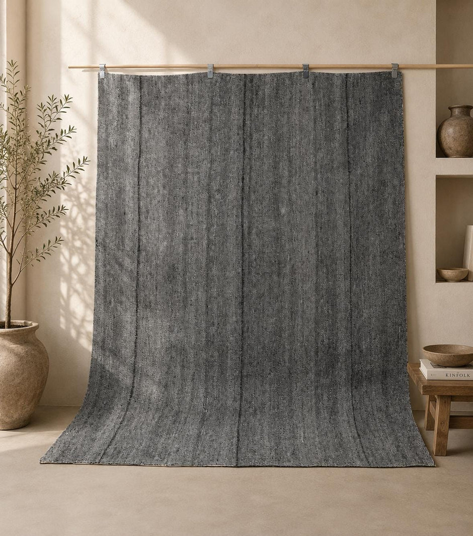 7x7 vintage Turkish flatweave rug hanging in styled room showing charcoal grey thin stripe pattern