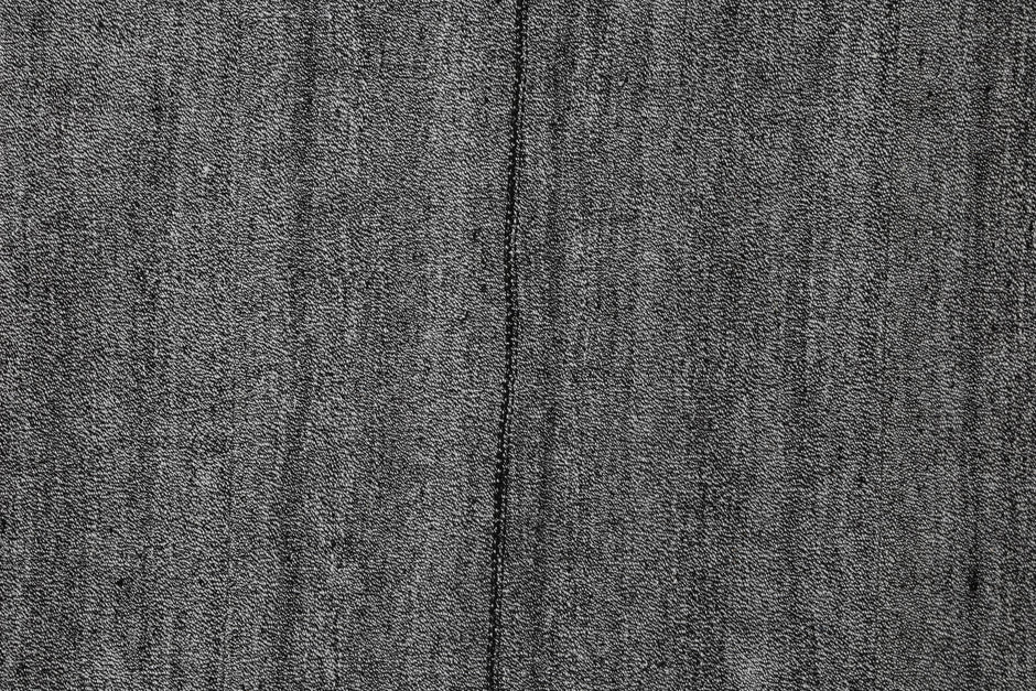 Full vintage Turkish minimal rug hanging with color palette swatches in black, grey and white