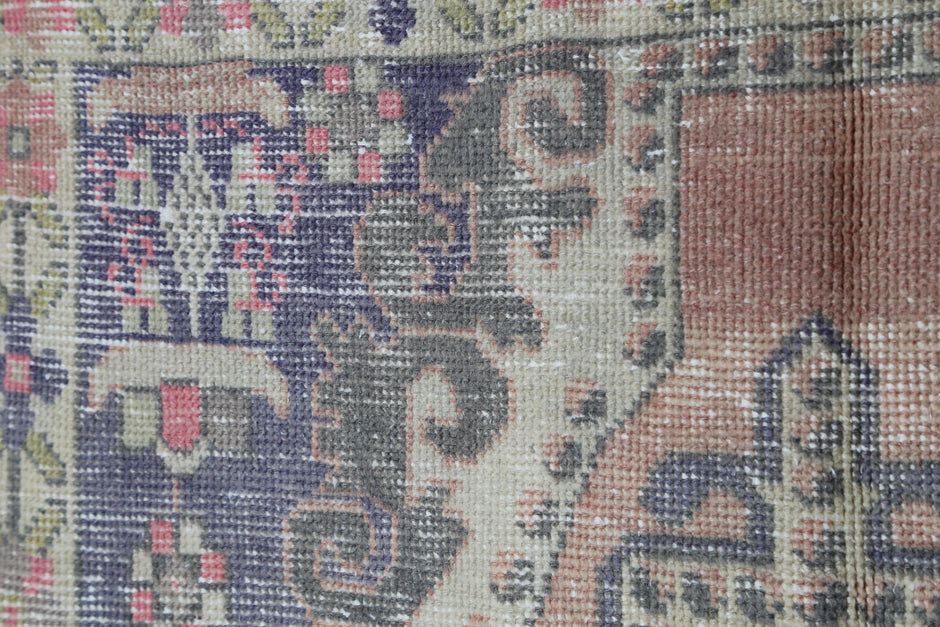 Back side of handmade multicolor wool cotton medallion rug showing weave texture