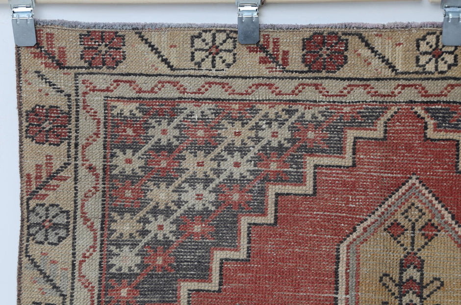 Back side of handmade red yellow and brown oriental runner showing weave texture