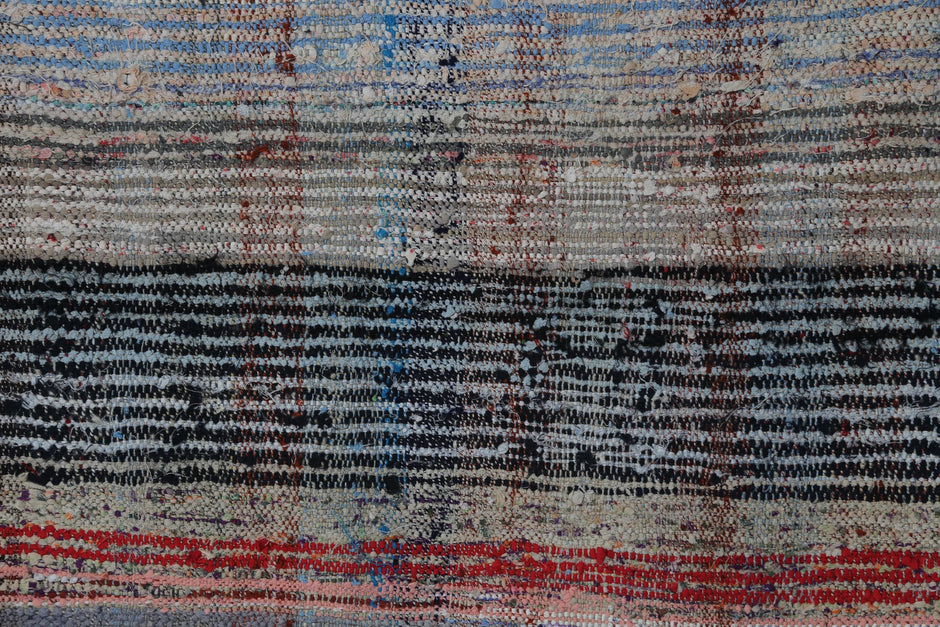 Vintage multicolor striped kilim runner displayed in narrow hallway