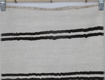 Back side of handmade white and black hemp wool runner showing weave texture