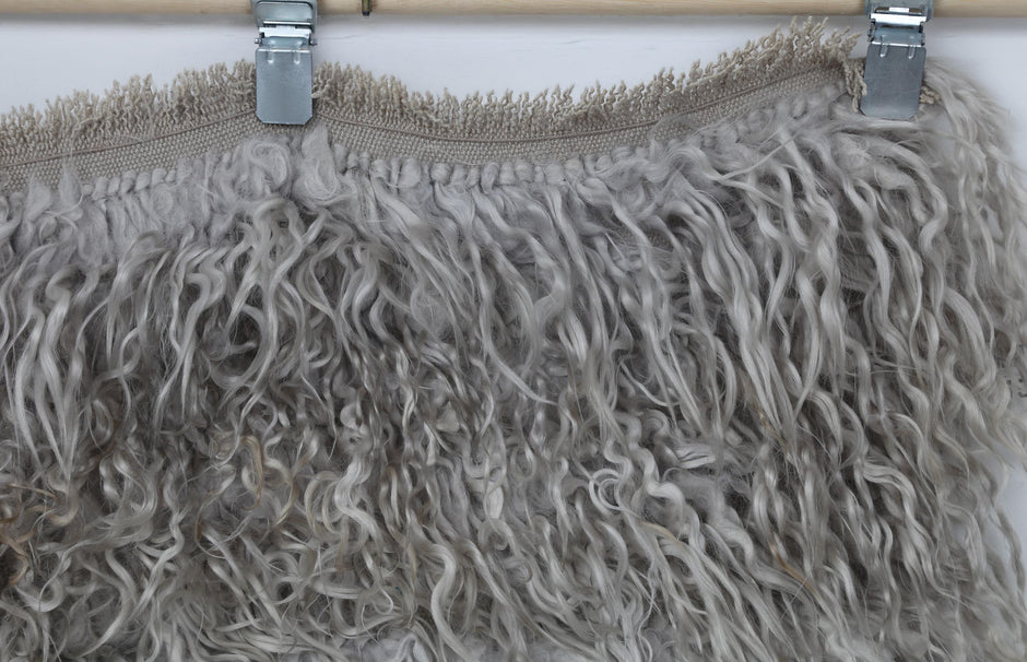 Back side of handwoven Turkish tulu rug showing weave base