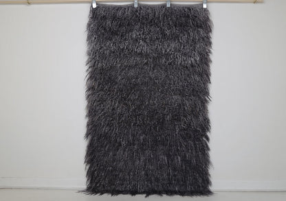 Close-up of flowing wool pile texture on charcoal gray tulu rug