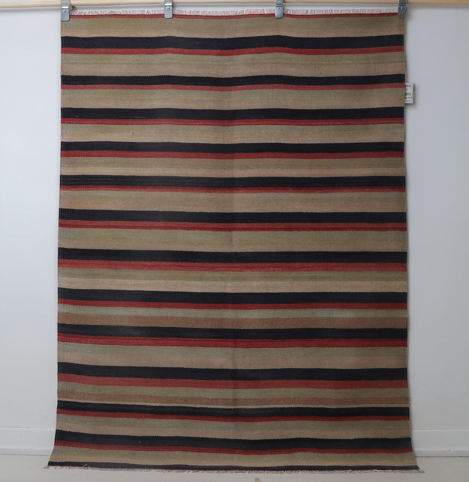 Close-up of earthy stripe detail on multicolor kilim rug