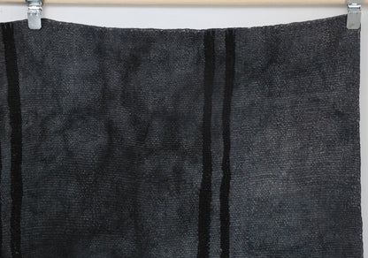 Layered geometric texture detail on handmade oversized hemp rug