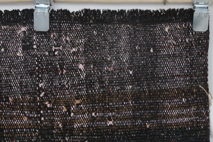 Vintage black red runner rug displayed in long corridor setting
