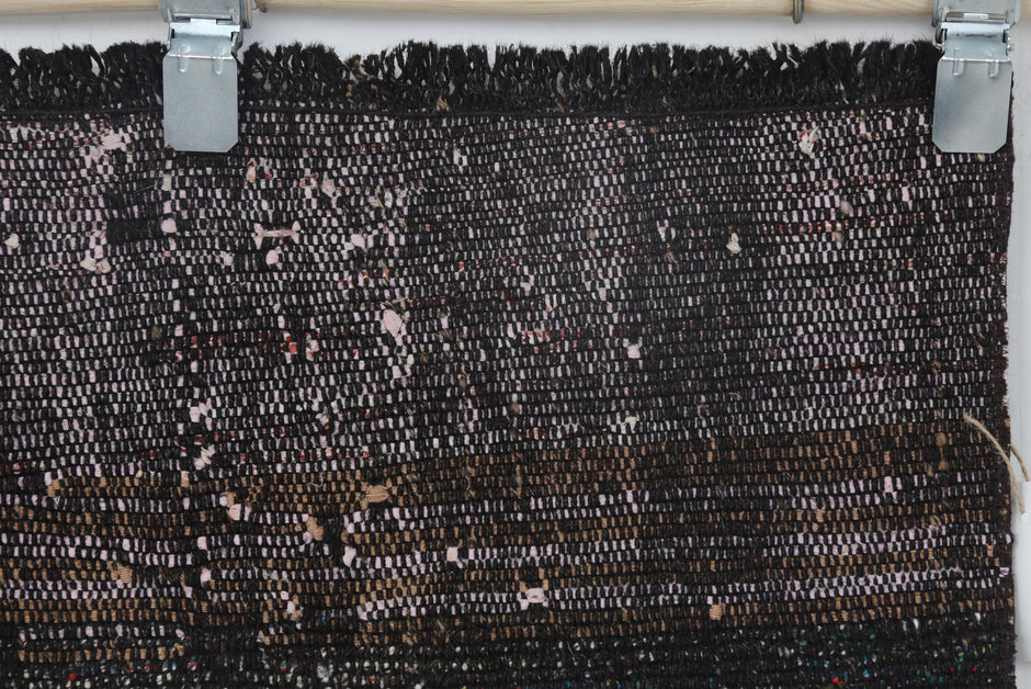Vintage black red runner rug displayed in long corridor setting