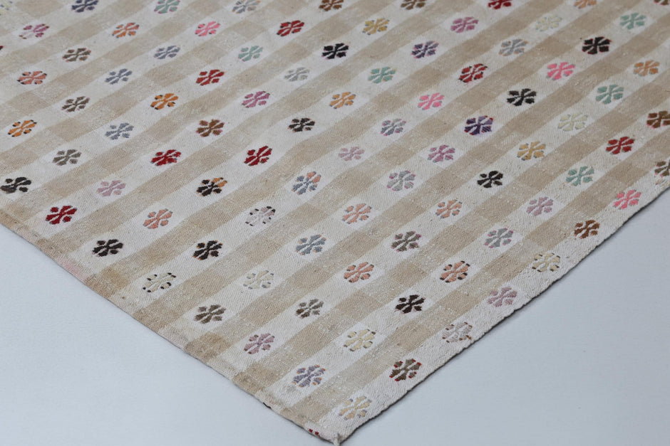 Back side of handmade beige and white kilim rug showing flatweave texture