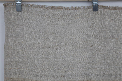 Close-up of striped detail on white beige hemp flatweave rug