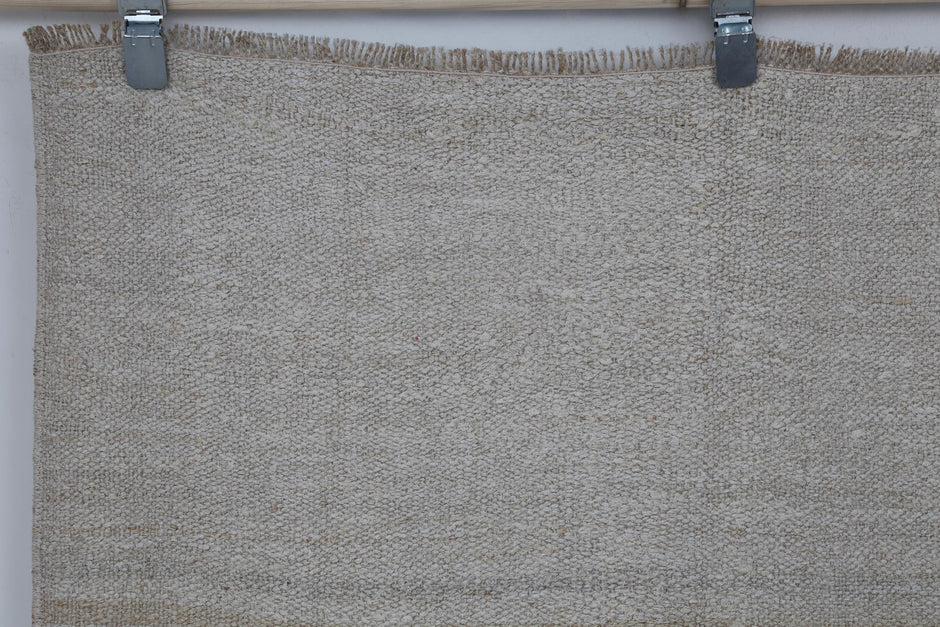 Close-up of striped detail on white beige hemp flatweave rug