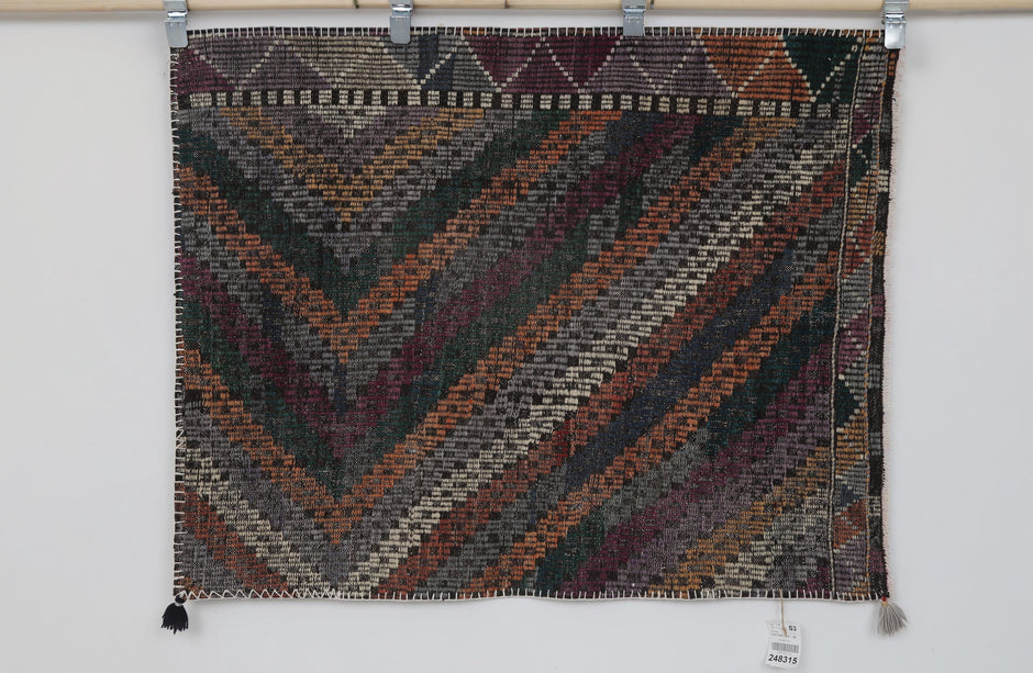 Close-up of diagonal geometric pattern on multicolor tribal tapestry